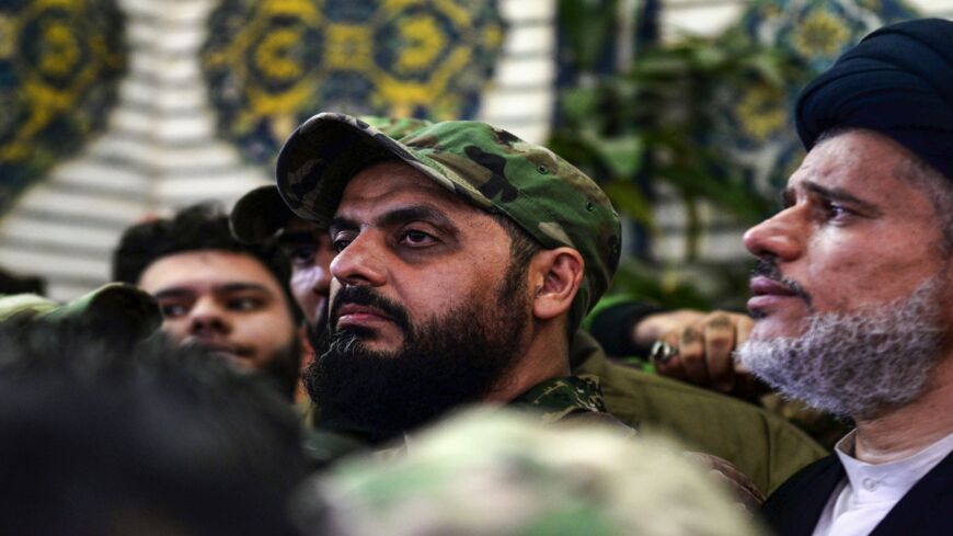 Qais al-Khazali (C) commander of the Asaib Ahl al-Haq pro-Iran faction attends the funeral procession of slain Iraqi paramilitary chief Abu Mahdi al-Muhandis, Iranian military commander Qasem Soleimani and eight others at the Imam Ali Shrine in the shrine city of Najaf in central Iraq on Jan. 4, 2020. 