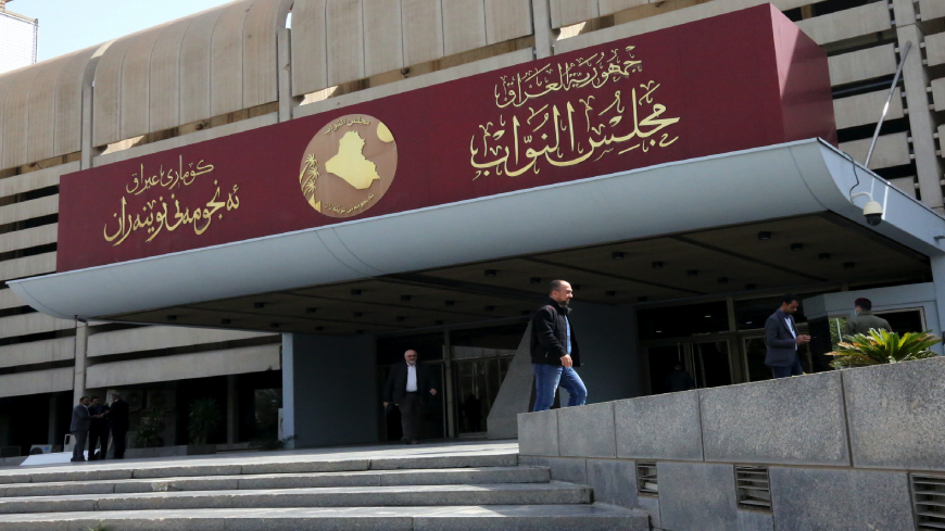 Iraqis stand outside parliament building, or Council of Representatives, in Baghdad's Green Zone on February 27, 2020. (Photo by SABAH ARAR / AFP) (Photo by SABAH ARAR/AFP via Getty Images)