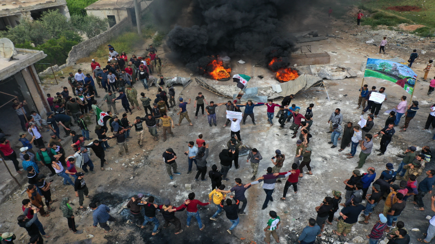 A drone images shows Syrian demonstrators gathering during a protest in the village of Maaret al-Naasan in Syria's Idlib province on May 1, 2020, to protests against a reported attack by Hayat Tahrir al-Sham, an alliance led by a former Al-Qaeda affiliate, on a protest the previous day. (Photo by Omar HAJ KADOUR / AFP) (Photo by OMAR HAJ KADOUR/AFP via Getty Images)