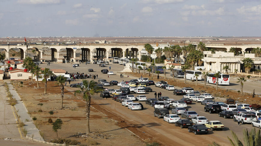 Vehicles wait to cross into Syria at the recently reopened Naseeb border post in Daraa province, at the Syrian-Jordanian border south of Damascus, Nov. 7, 2018.