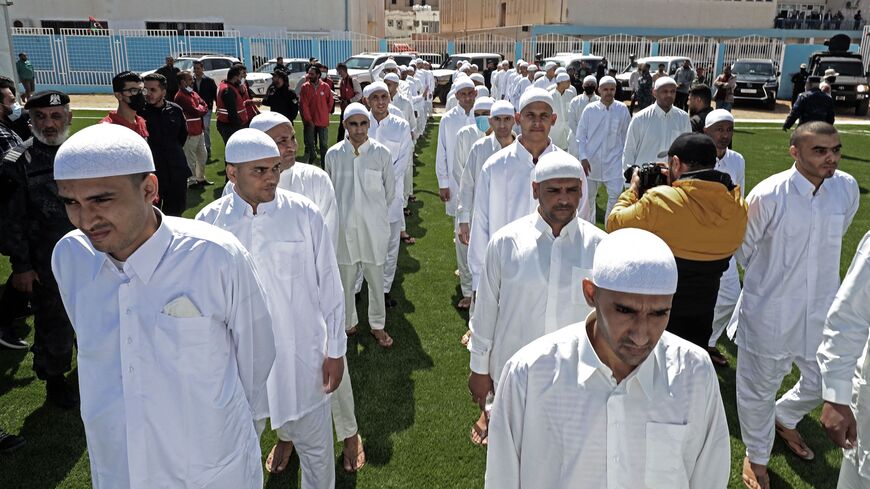 Prisoners of war, loyal to the forces of Libya's eastern military strongman Khalifa Haftar, are pictured upon their release by the new Libyan unity government on March 31, 2021 in the port city of Zawiya, 50 kilometres (30 miles) west of the Libyan capital Tripoli, following the latest peace deal between the North African country's former rival governments. - The two sides have completed more than one prisoner swap this year as Libya's eastern administration officially handed over power to a new executive t