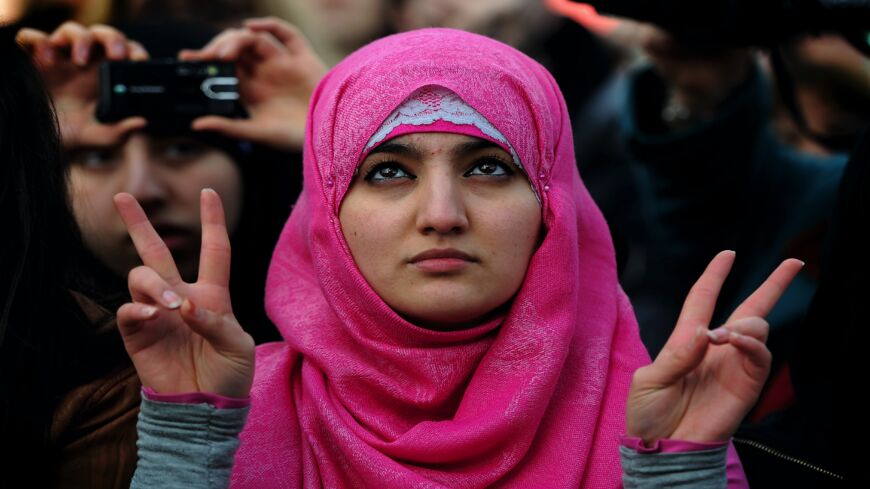 A protestor makes the "victory sign" with her hands during a global solidarity demonstration for political change in Egypt in Trafalgar Square, London, on Feb. 12, 2011. The event was organized by Amnesty International and the ITUC, Human Rights Watch, the NUS, the Cairo Institute for Human Rights Studies, the Egyptian Initiative for Personal Rights, the Euro-Mediterranean Human Rights Network and the Arab Program for Human Rights Activists.