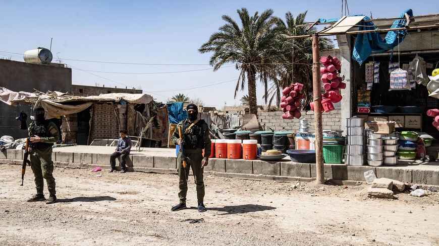 Fighters of the Kurdish-led Syrian Democratic Forces stand guard in the village of Baghouz in northern Deir ez-Zor province, Syria, March 24, 2021.