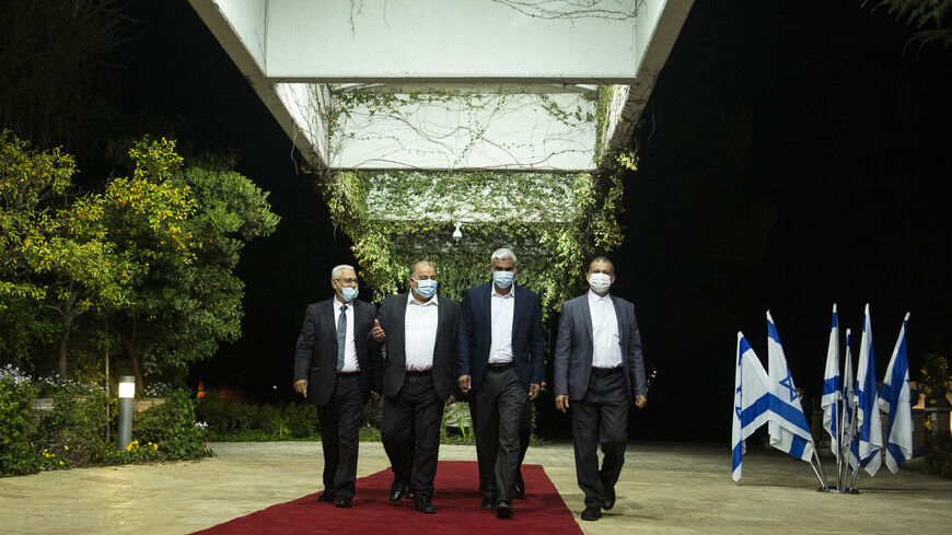 Ra'am Party leader Mansour Abbas and other party members attend a meeting with President Reuven Rivlin at the President's residence on April 5, 2021 in Jerusalem. 