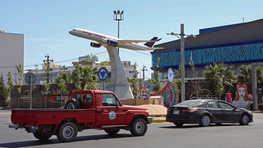 The model of an airplane of Iraqi Kurdish carrier "Zagrosjet" decorates the center of a roundabout near Erbil's International airport in the capital of Iraq's autonomous northern Kurdish region on April 15, 2021. An explosives-packed drone slammed into the Erbil airport late on April 14 in the first reported use of such a weapon against a base used by US-led coalition troops in the country, according to officials. It comes after around 20 bomb and rocket attacks blamed on pro-Iran Shiite armed groups agains