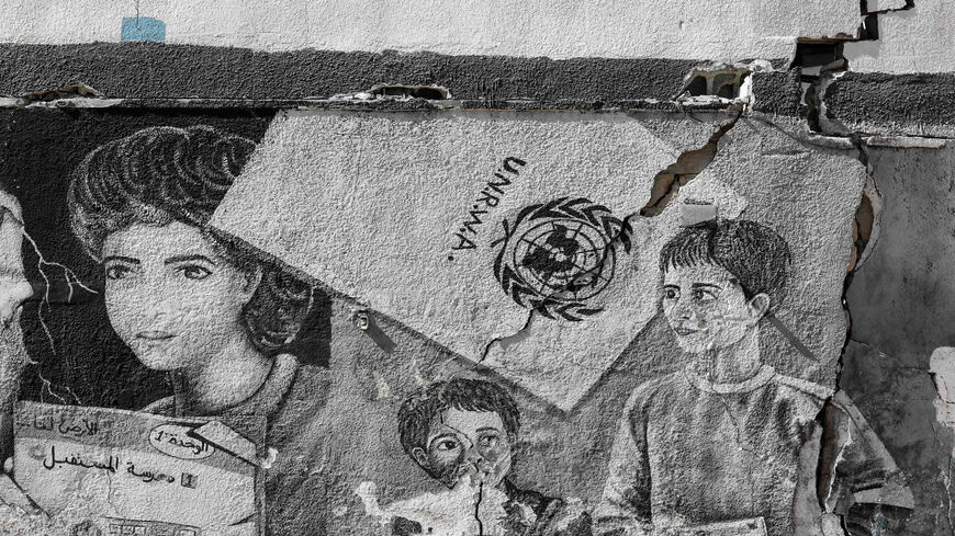 Cracks show on a mural covering the wall of the United Nations Relief and Works Agency (UNRWA) headquarters in Gaza City's Rimal neighborhood, following Israeli air raids, Gaza Strip, May 18, 2021.