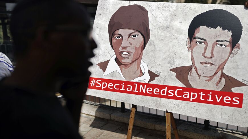 Ilan Mengistu (L), brother of Avera Mengistu (C), one of two Israelis held by Hamas in Gaza since 2014, attends a press conference organized by the captives' families calling for their release, in Jerusalem on Sept. 6, 2018. 