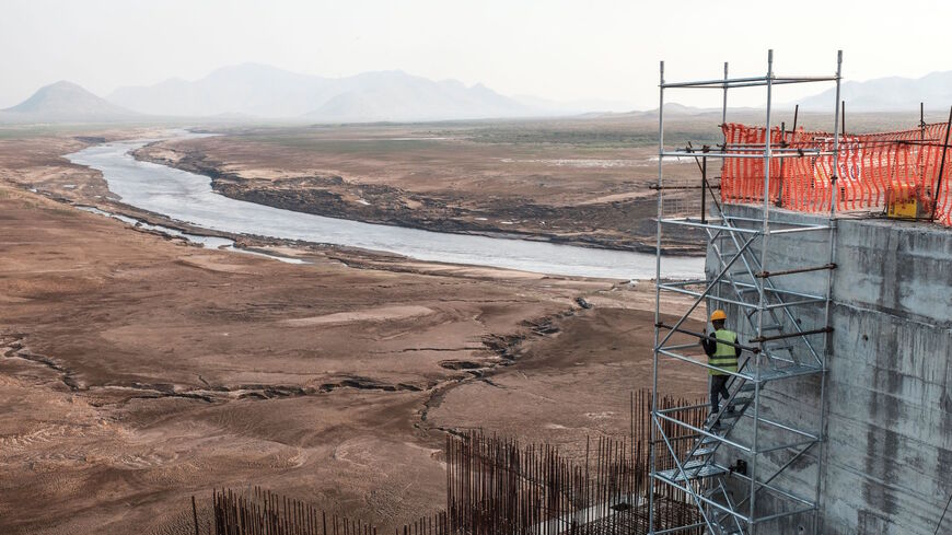 A worker goes down a construction ladder at the Grand Ethiopian Renaissance Dam (GERD), near Guba in Ethiopia, on December 26, 2019. 