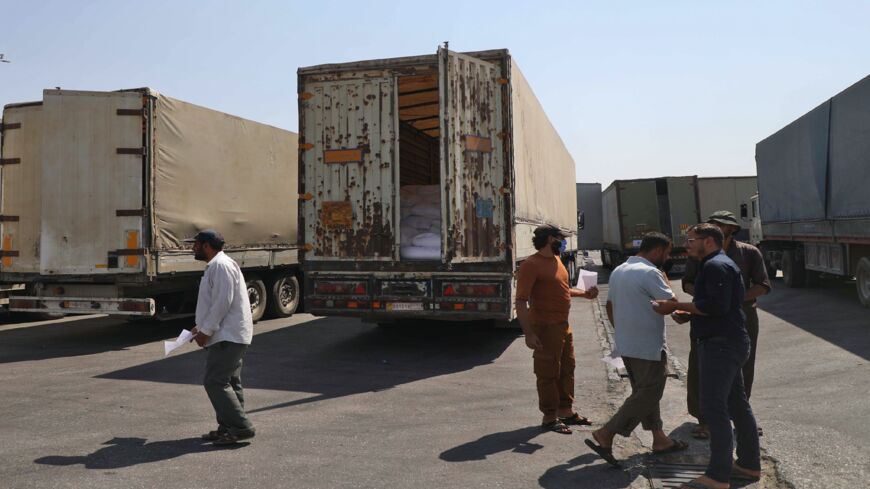 International humanitarian aid trucks cross into Syria's northwestern Idlib province through the Bab al-Hawa border crossing with Turkey, on Sept. 7, 2020.