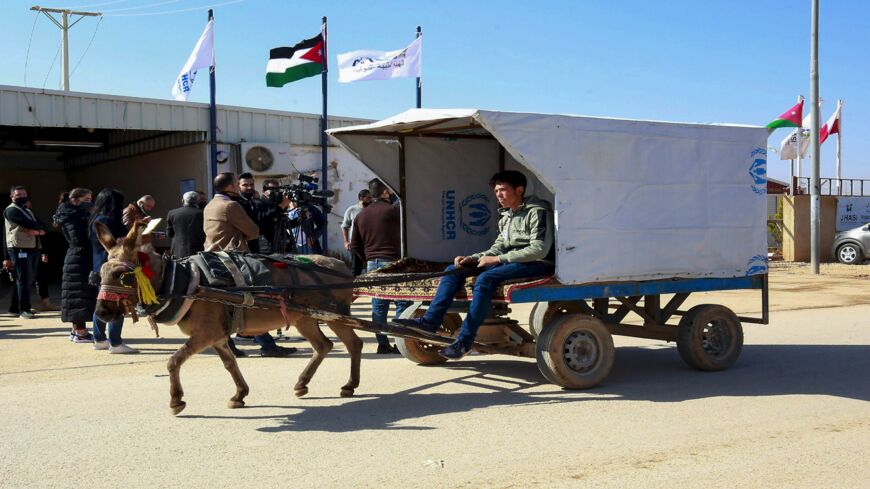 A Syrian refugee rides a donkey cart at the Zaatari refugee camp, 80 kilometers (50 miles) north of the Jordanian capital, Amman, on Feb. 15, 2021.