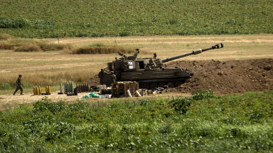 An artillery unit soldier walks near an artillery unit near the border with the Gaza Strip, in Sderot, Israel, May 20, 2021.