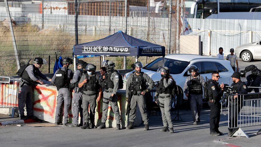 Israeli security forces stand guard to prevent Palestinians from passing through an Israeli police checkpoint at the entrance of the Sheikh Jarrah neighborhood, during a protest by demonstrators demanding the reopening of the roadblock,  East Jerusalem, May 29, 2021.