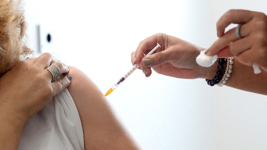 A woman receives a dose of Pfizer BioNTech vaccine against COVID-19 at the Ankara City Hospital, in Ankara, Turkey, on June 7, 2021. 