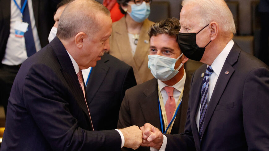 US President Joe Biden (R) speaks with Turkey's President Recep Tayyip Erdogan prior to a plenary session of a NATO summit at the North Atlantic Treaty Organization (NATO) headquarters in Brussels, on June 14, 2021.  