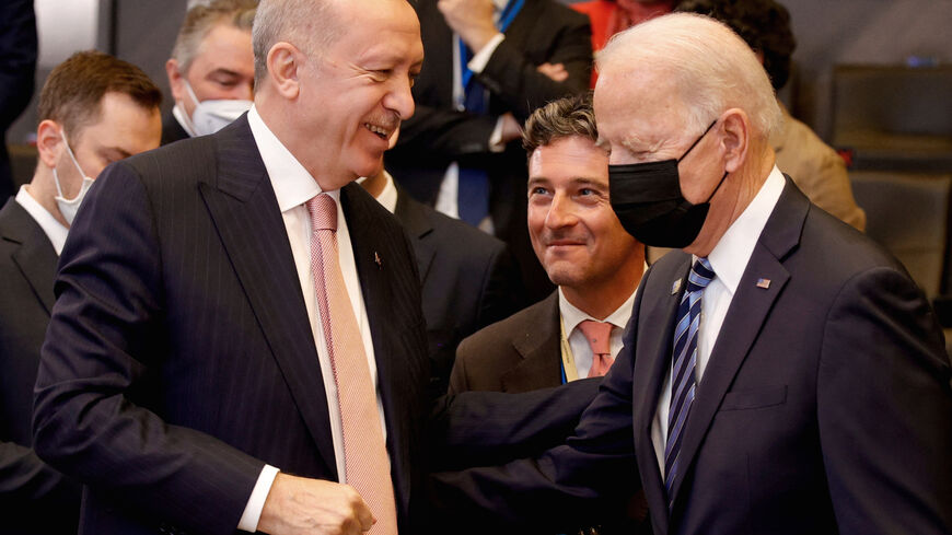 US President Joe Biden (R) speaks with Turkey's President Recep Tayyip Erdogan prior to a plenary session of a NATO summit at the North Atlantic Treaty Organization (NATO) headquarters in Brussels, on June 14, 2021.