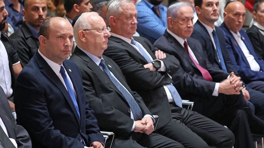 Israeli Prime Minister Naftali Bennett, President Reuven Rivlin, Defense Minister Benny Gantz, and ousted premier Benjamin Netanyahu attend a memorial service at the Mount Herzel military cemetery in Jerusalem on June 20, 2021, commemorating soldiers who died in the 2014 Gaza war.