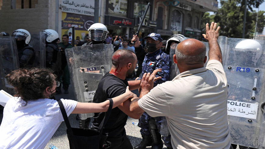 Palestinian security forces push a protest during a demonstration calling for Palestinian President Mahmoud Abbas to quit, following the death of Palestinian human rights activist Nizar Banat who died shortly after being arrested, Ramallah, West Bank, June 24, 2021.