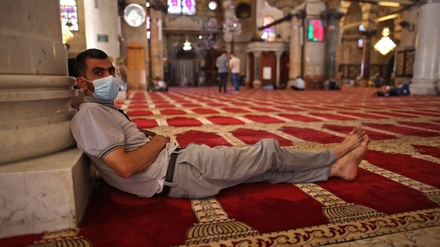 masked worshipper at Al-Aqsa Mosque compound