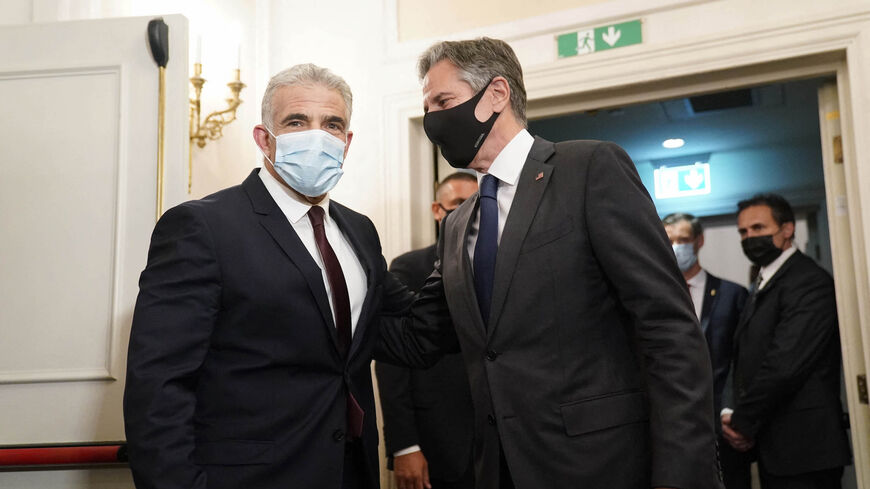 Secretary of State Antony Blinken (C) greets Israeli Foreign Minister Yair Lapid ahead of their meeting in Rome, on June 27, 2021. 