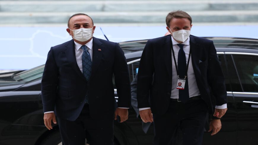 Turkish Foreign Minister Mevlut Cavusoglu (L) attends the second international Libya conference on June 23, 2021, in Berlin, Germany. 