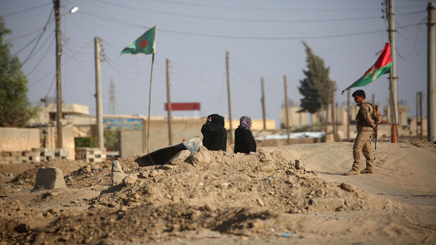 Syrian civilians wait at a checkpoint of the Syrian Democratic Forces on the western entrance of Raqqa as they are prevented by forces from entering the the embattled city, Syria, Oct. 26, 2017.