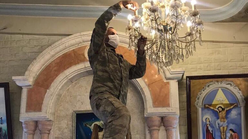 Turkish soldiers carry out maintenance work at the Syriac Orthodox Church of Mar Tuma in the center of Ras al-Ain, Syria, in a photo posted July 14, 2021.