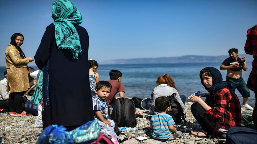 Migrants from Afghanistan arrive after crossing the Aegean Sea from Turkey with a dinghy on the Greek Mediterranean island of Lesbos, Greece, Aug. 6, 2018.