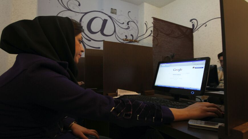 An Iranian woman surfs the internet at a cybercafe in central Tehran on Jan. 24, 2011.