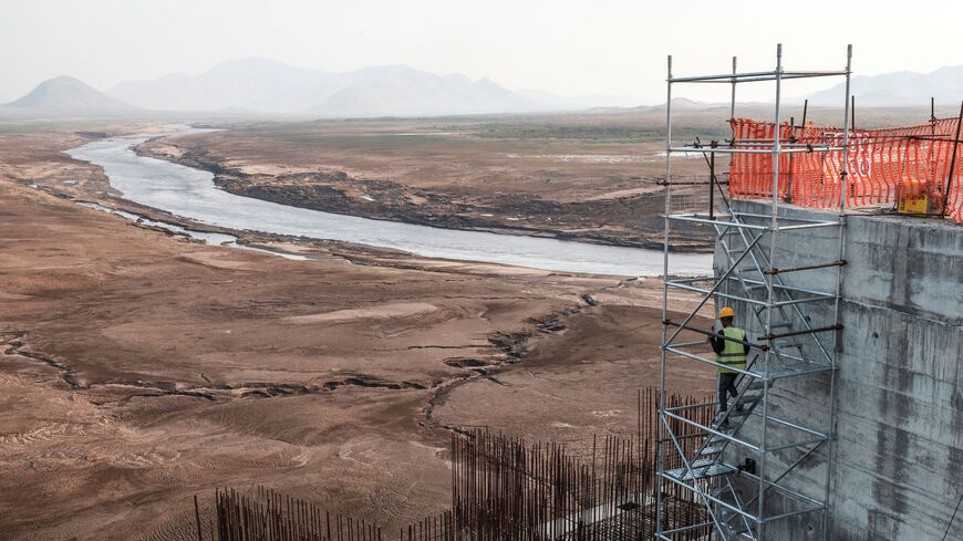 A worker goes down a construction ladder at the Grand Ethiopian Renaissance Dam (GERD), near Guba in Ethiopia, on Dec. 26, 2019. 