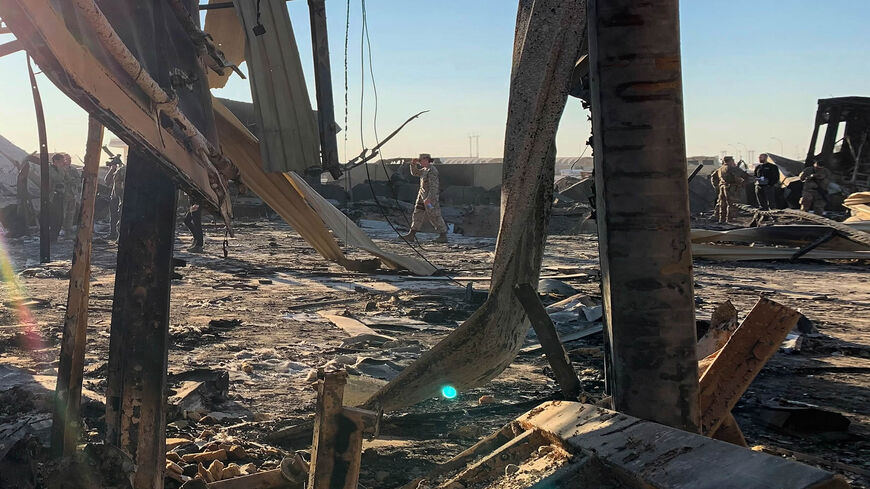 This photo taken during a press tour organized by the US-led coalition fighting the remnants of the Islamic State shows US soldiers clearing rubble at Ain al-Asad military air base, Anbar province, Iraq, Jan. 13, 2020.