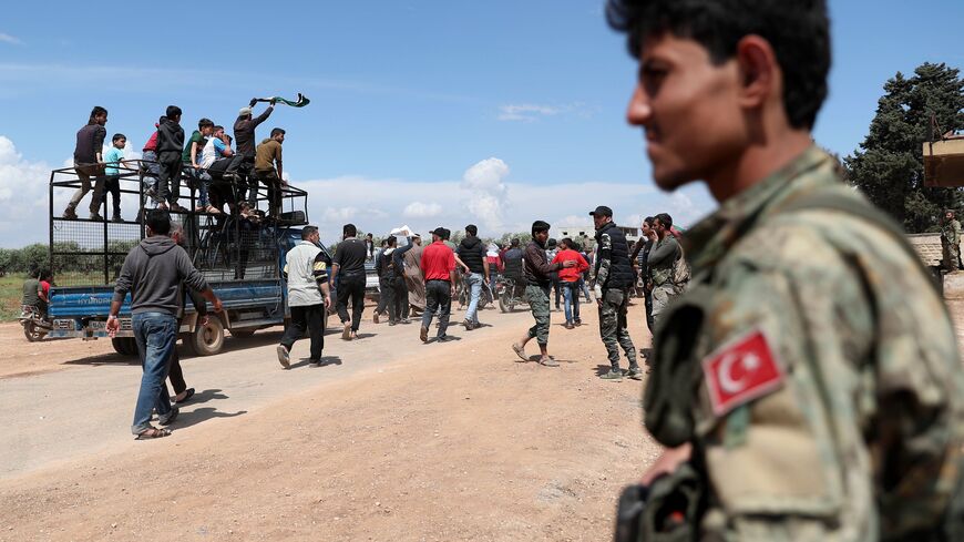 Demonstrators gather during a protest in the village of Maaret al-Naasan in Idlib province, to protest against a reported attack by Hayat Tahrir al-Sham, Syria, May 1, 2020.