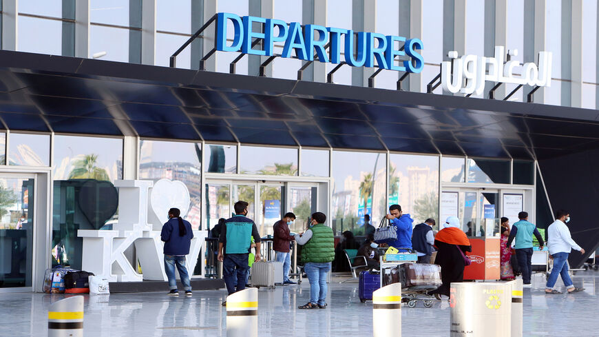 Passengers wait at the departure gate at Kuwait international airport, after a 12-day closure to stem the spread of the coronavirus pandemic, Kuwait City, Kuwait, Jan. 3, 2021.