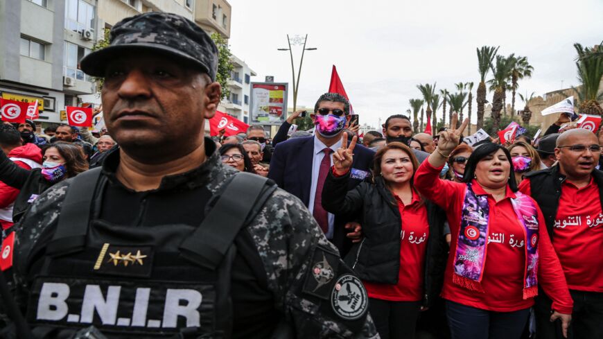 A member of Tunisia's special forces' national brigade for rapid intervention (BNIR) marches on duty ahead of the leader of the Free Destourian Party, Abir Moussi (2nd-R).