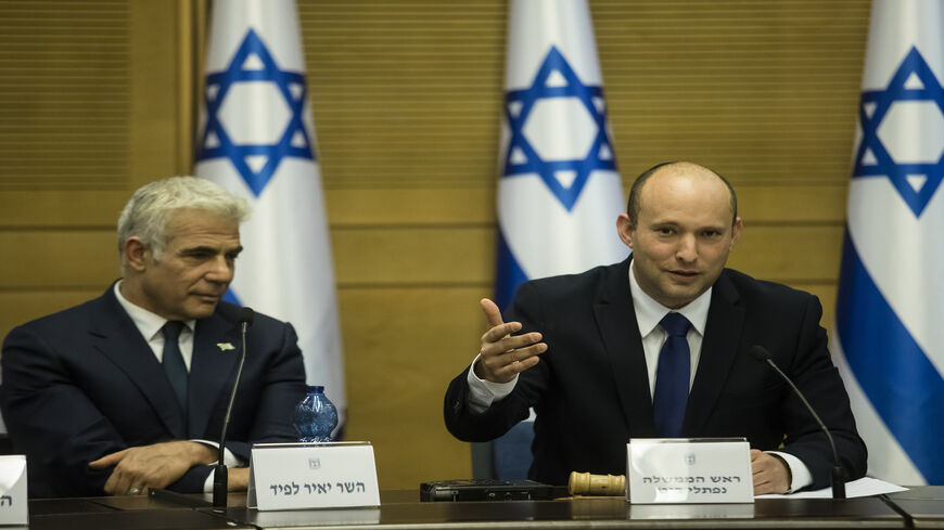 Incoming Israeli Prime Minister Naftali Bennett (R) and Foreign Minister Yair Lapid attend the first meeting of the new government, Jerusalem, June 13, 2021.