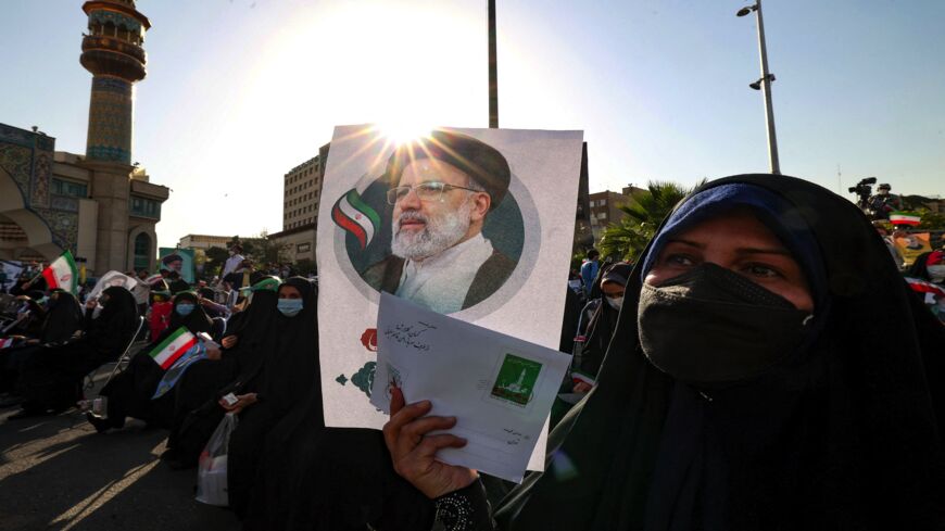 Supporters of Iranian ultraconservative presidential candidate Ebrahim Raisi carry a poster bearing his picture as they attend a rally in the capital, Tehran, on June 16, 2021, ahead of the Islamic Republic's June 18 presidential election. 