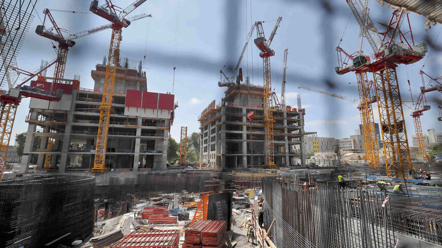 This picture shows a view of ongoing work at a construction site in the coastal city of Tel Aviv, Israel,  July 12, 2021.