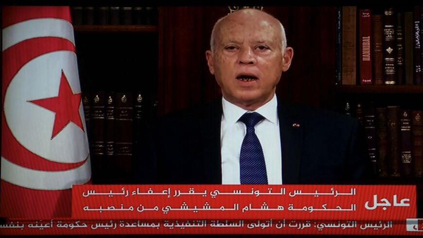 In a photo taken from the TV station of President Kais Saied, the president announces the dissolution of parliament and Prime Minister Mechichi's government on July 25, 2021.