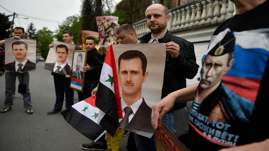 Protesters hold Syrian flags, posters and pictures of late Serbian strongman Slobodan Milosevic and Syrian President Bashar al-Assad, as they demonstrate against Western airstrikes against the Syrian regime, Belgrade, Serbia, April 15, 2018.