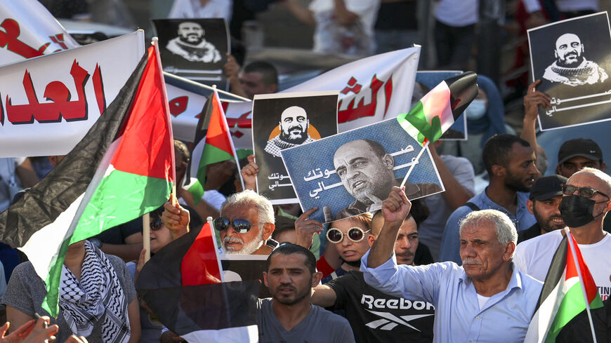 Palestinian protesters rally denouncing the Palestinian Authority (PA) in the aftermath of the death of activist Nizar Banat while in the custody of PA security forces, Ramallah, West Bank, July 17, 2021.