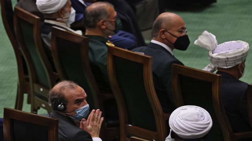 European External Action Service (EEAS) Deputy Secretary-General Enrique Mora (C) looks on as Iran's newly elected president, Ebrahim Raisi, speaks.