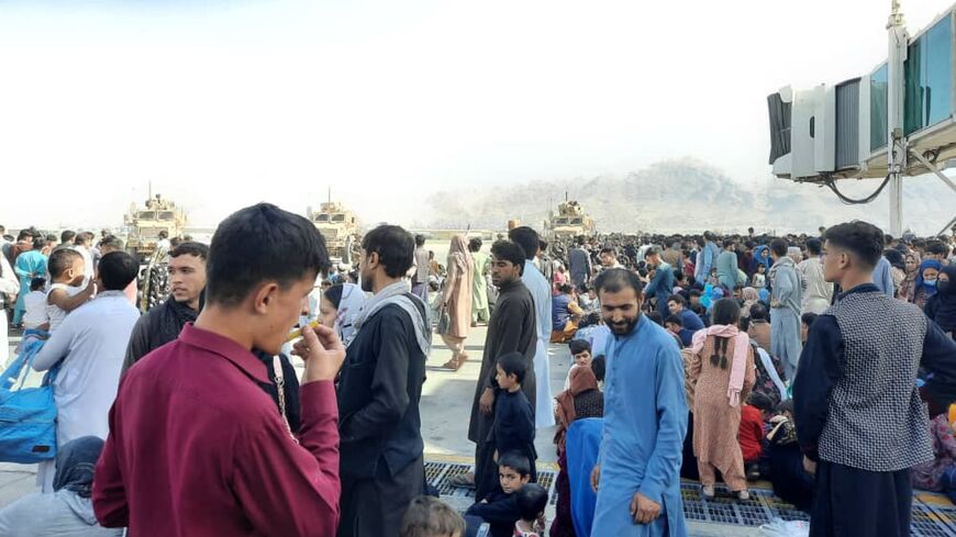 Afghans crowd Kabul airport tarmac on Aug. 16