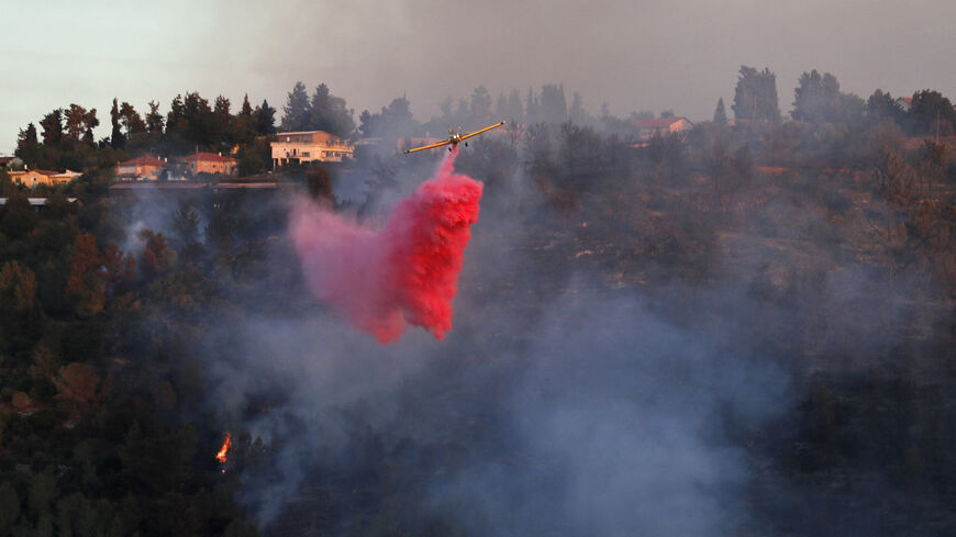 A firefighting plane works on extinguishing a forest fire at the Jerusalem mountains near Shoresh, on Aug. 16, 2021.