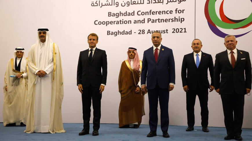 (L to R) Qatars Emir Sheikh Tamim al-Thani, French President Emmanuel Macron, Saudi Foreign Minister Faisal bin Farhan, Iraq's Prime Minister Mustafa al-Kadhemi, Turkey's Foreign Minister Mevlut Cavusoglu, and Jordan's King Abdullah II pose for a group picture after the meeting in Baghdad on Aug. 28, 2021. 