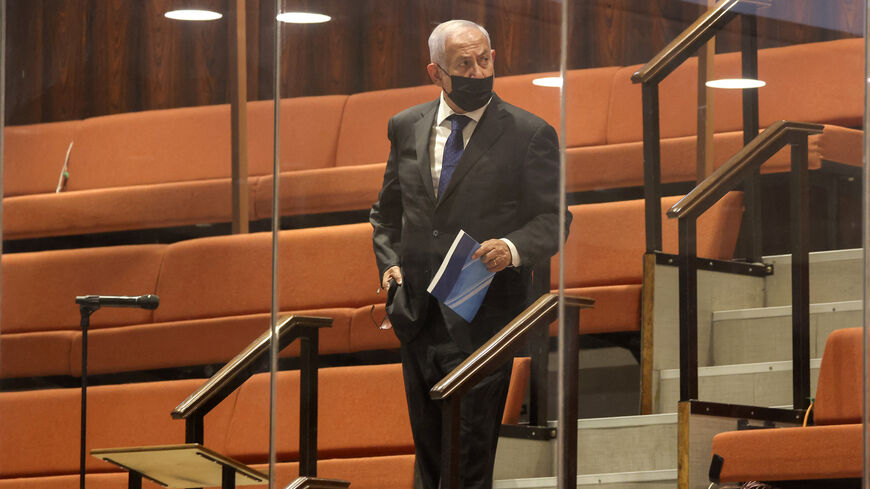 Former Israeli prime minister Benjamin Netanyahu stands behind a glass panel (due to quarantine regulations) at the Knesset (Israeli parliament) from the guest bleachers of the plenum hall during a plenum session on the state budget on Sept. 2, 2021. 