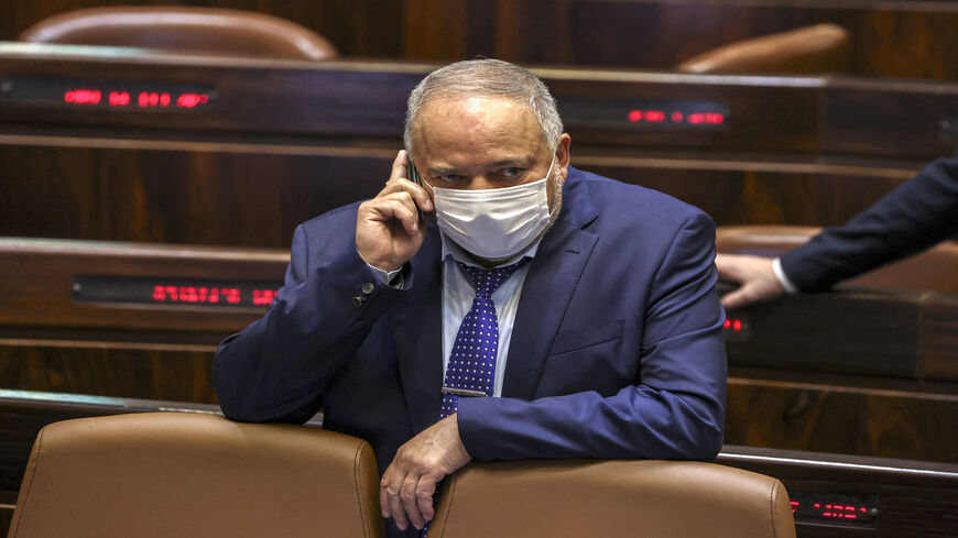 Israeli Finance Minister Avigdor Liberman speaks on his cellphone as he attends a plenum session on the state budget, Jerusalem, Sept. 2, 2021.