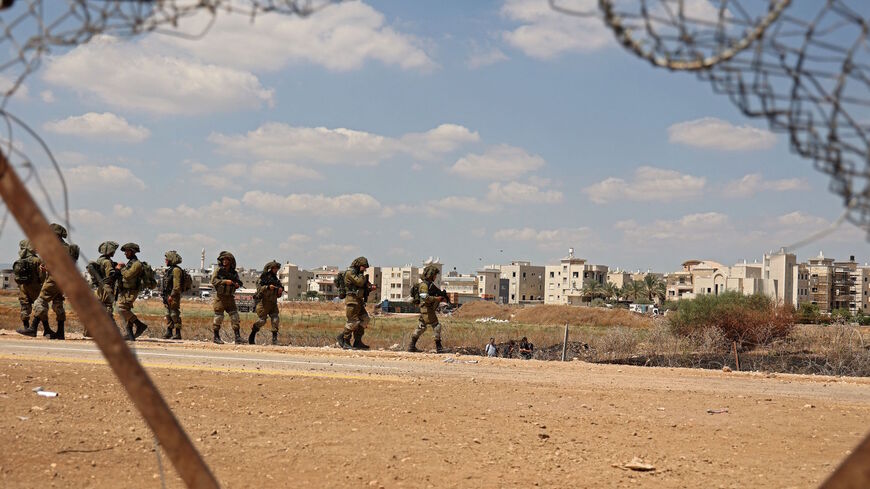 Israeli soldiers patrol near a hole in a security fence in the West Bank town of Jenin, on Sept. 6, 2021, following the break out of six Palestinians from an Israeli prison.