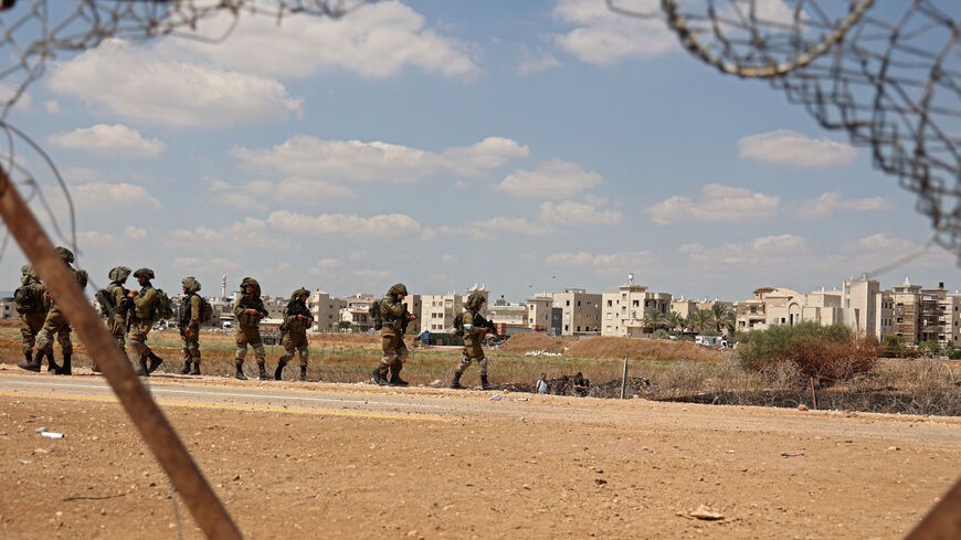 Israeli soldiers patrol near a hole in a security fence in the West Bank town of Jenin, on Sept. 6, 2021, following the break out of six Palestinians from an Israeli prison. 