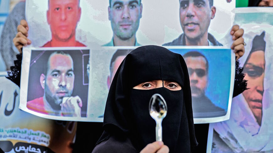 A demonstrator holds up a spoon, reportedly the digging tool used by six Palestinian prisoners who escaped from Israel's Gilboa prison, during a rally in solidarity with them in Khan Yunis in the southern Gaza Strip on Sept. 8, 2021.