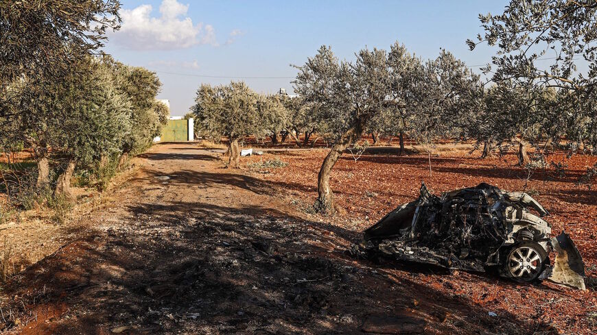 This picture taken on Sept. 20, 2021 shows a view of vehicle destroyed by what is believed to be a drone strike, on the northeastern outskirts of Syria's rebel-held northwestern city of Idlib. 