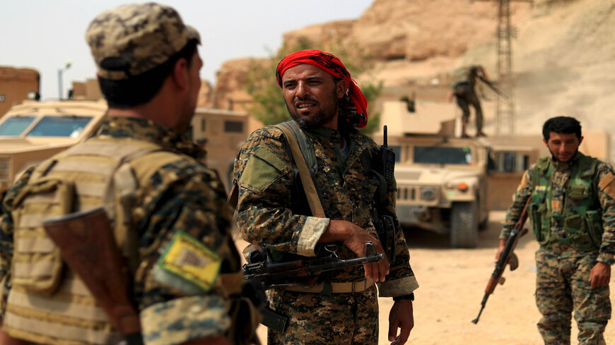 Members of the Syrian Democratic Forces gather in the village of Susah in the eastern province of Deir ez-Zor, near the Syrian border with Iraq, Sept. 13, 2018. 